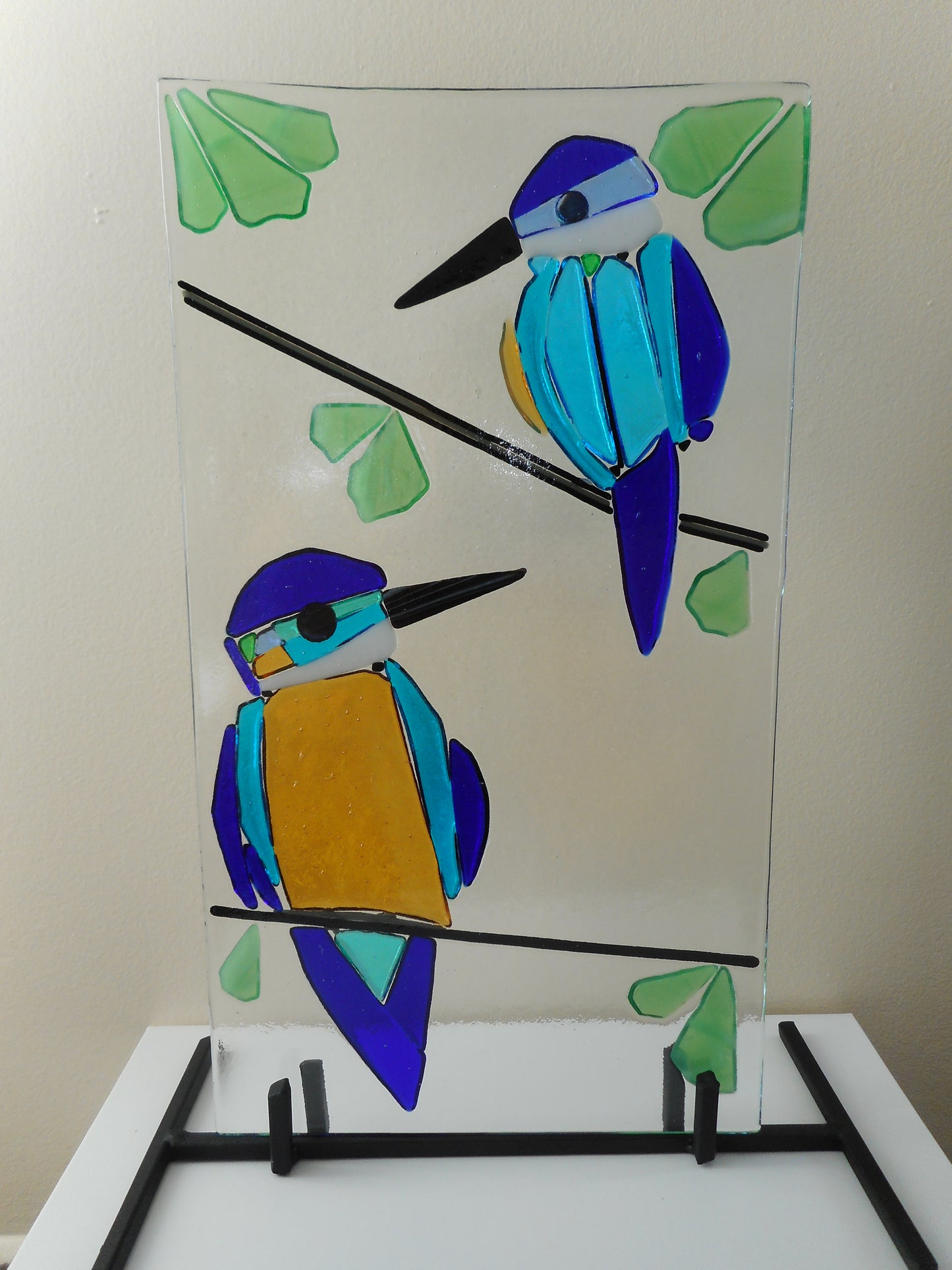 Colourful Kingfishers on a Black Metal Stand