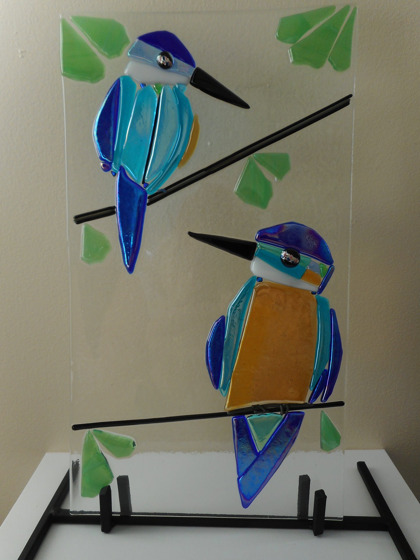 Colourful Kingfishers on a Black Metal Stand